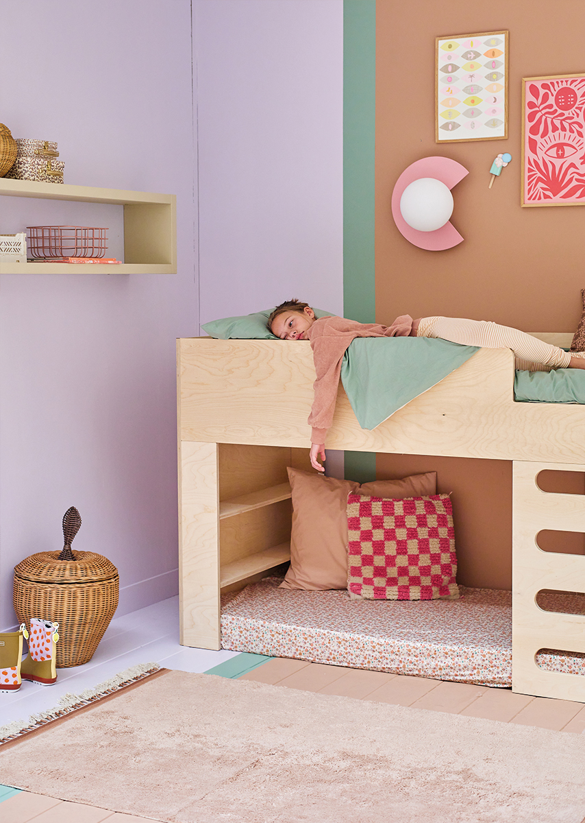 Kinderbed met zeegroen beddengoed en lila muur
